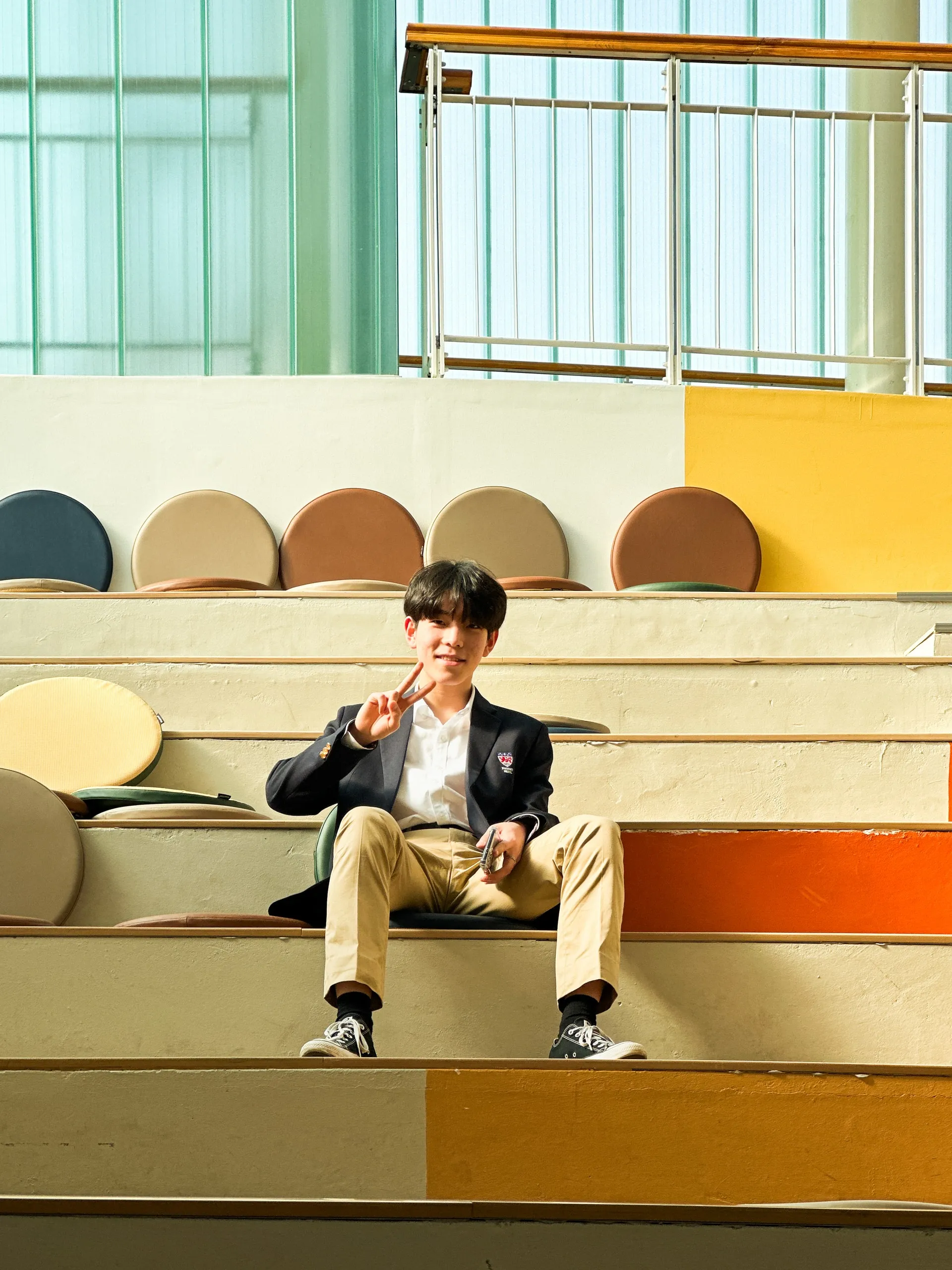 A friend on the colourful steps. Peace sign up.