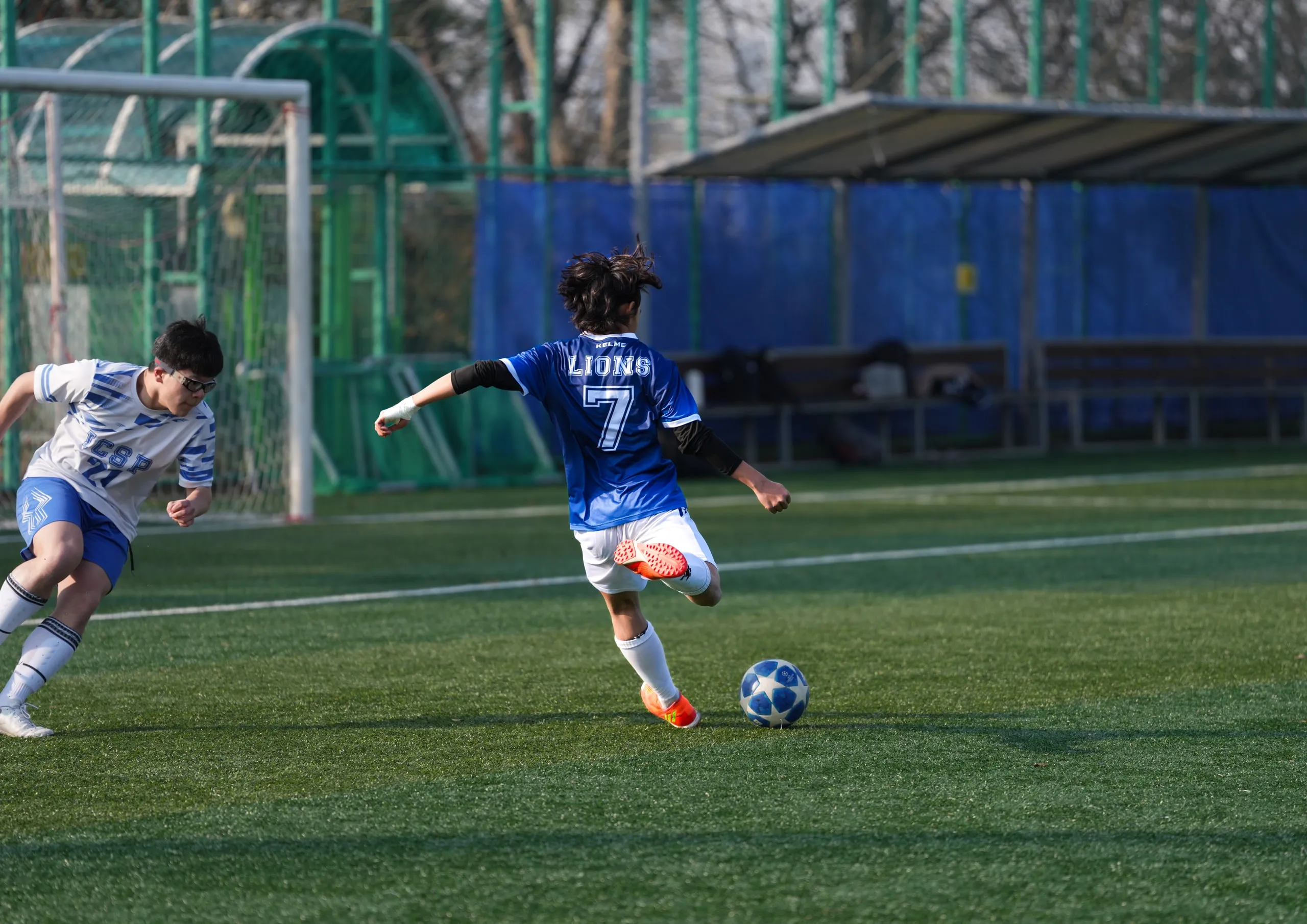 Number 7 again, same game. Ball at his feet, defender closing in.
