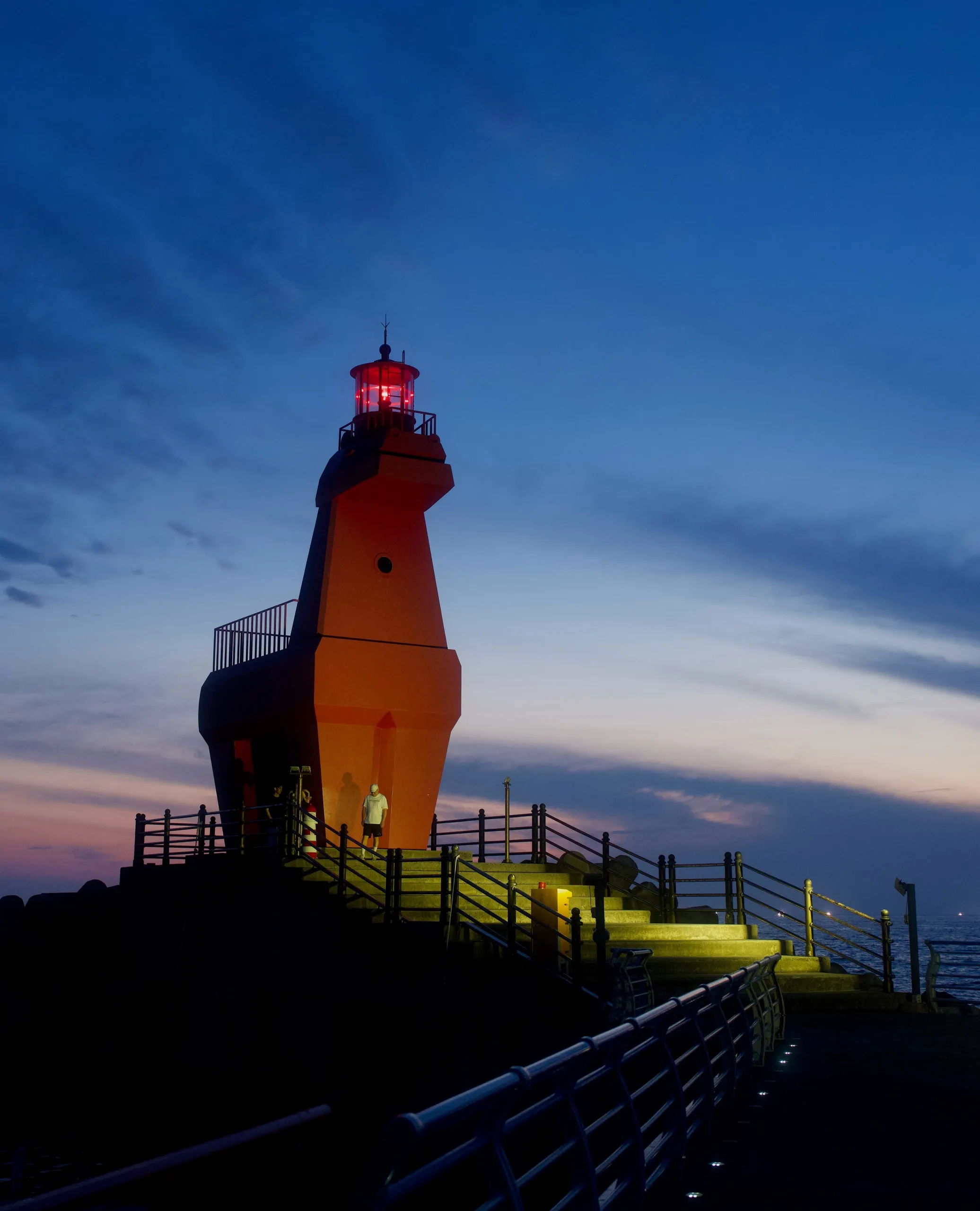The red horse lighthouse at Iho Tewoo, Jeju, after dark.